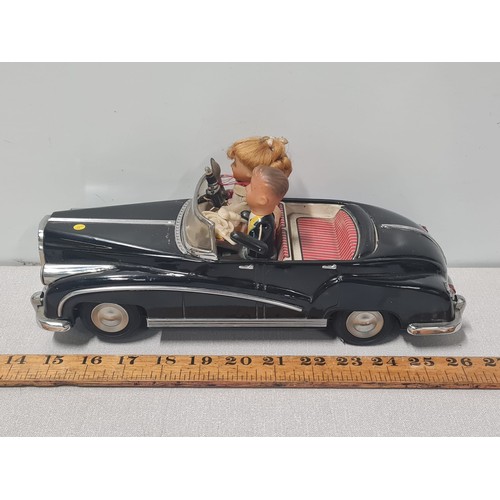 61 - Vintage metal electric car with figures in working order.
Approx 31cm Long