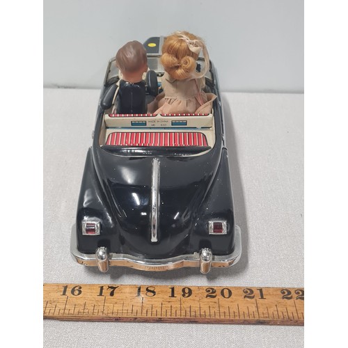 61 - Vintage metal electric car with figures in working order.
Approx 31cm Long