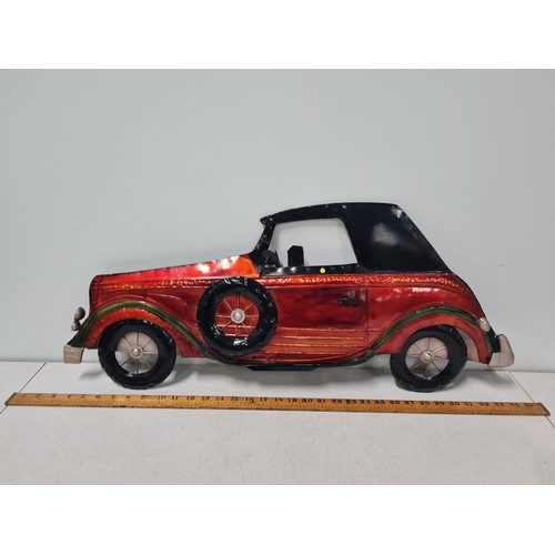 322 - Large metal car wall hanging. 79cm long.