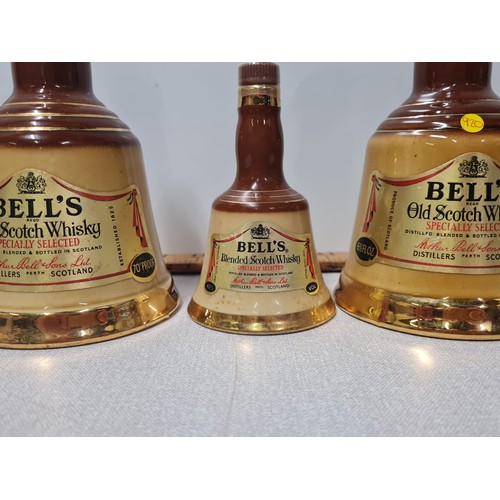 12 - 3 x Vintage Bells Scotch whisky in Wade decanters all full and sealed.