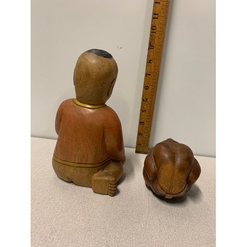 94 - Carved wooden Buddha figure along with hand carved solid wood weeping Buddha.