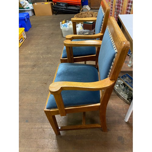 162 - Pair of solid oak arm chairs with blue velvet upholstery.