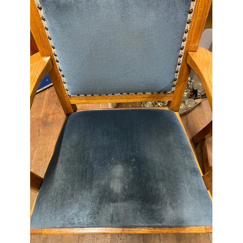 162 - Pair of solid oak arm chairs with blue velvet upholstery.