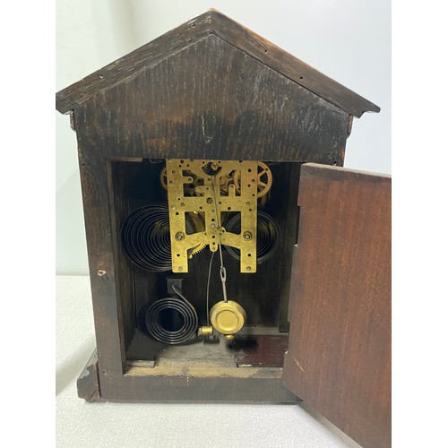 173 - Vintage oak cased clock and pendulum.