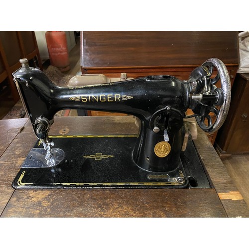 398 - Singer treadle sewing machine in original cabinet.