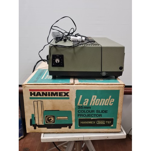 584 - Hanimex La Ronde projector and screen.