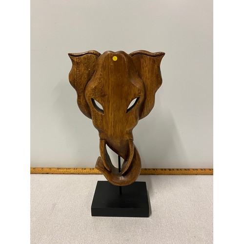 49 - Carved wooden elephant face on stand. 36cm tall.