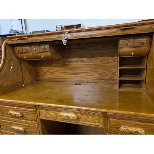 104 - Large solid oak roll top writing bureau. 136cm x 133cm x 73cm.