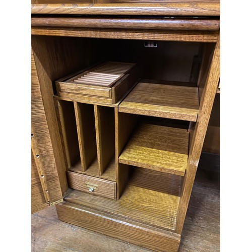 104 - Large solid oak roll top writing bureau. 136cm x 133cm x 73cm.