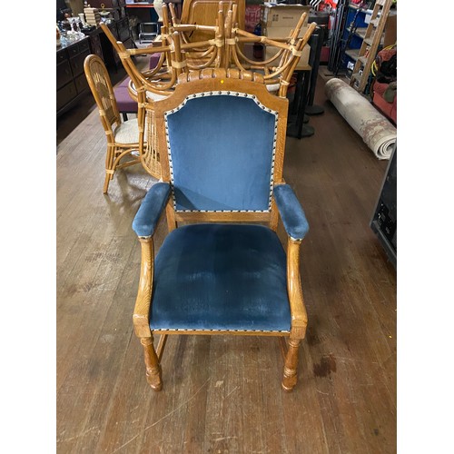 115 - Solid oak throne chair with blue velvet upholstery.