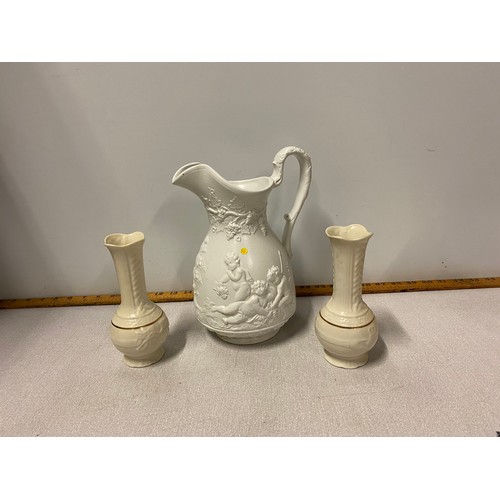 267 - Pair of Belleek bud vases along with ceramic water jug depicting cherubs.