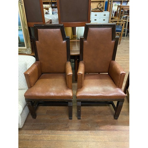 299 - Pair of brown leather throne style arm chairs.