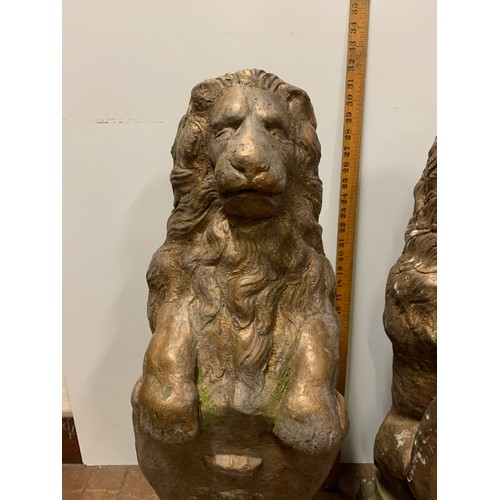 57 - Pair of large vintage stone garden lions holding shields. Very heavy.
78cm Tall