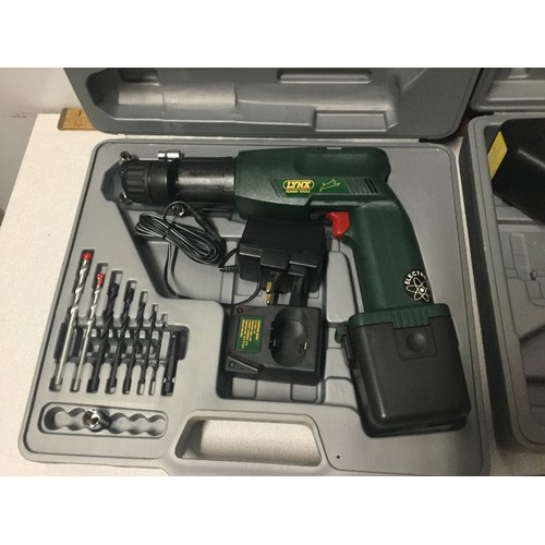 85 - 2 boxed Lynx drills and accessories. Only one charger works.