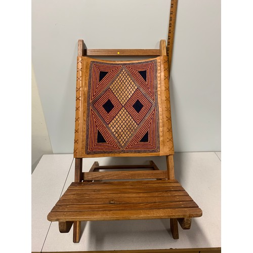 126 - Indian wooden folding chair with embroidered leather back.