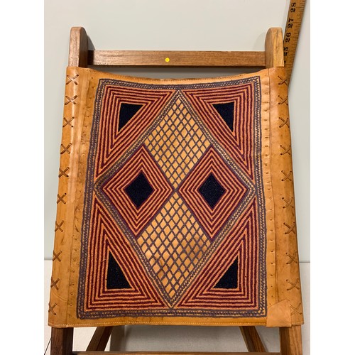 126 - Indian wooden folding chair with embroidered leather back.