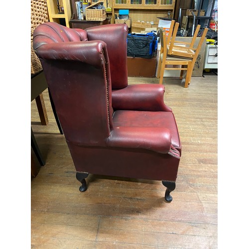 26 - Oxblood leather Chesterfield wing back chair.