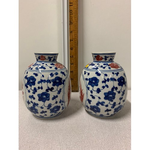 73 - Pair of Oriental blue and white vases with red bird design.