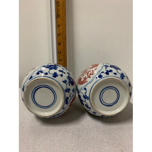 73 - Pair of Oriental blue and white vases with red bird design.