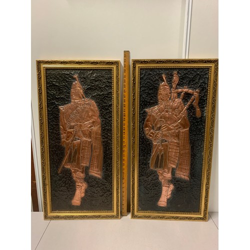 76 - Pair of signed hand crafted copper piper wall hangings.
87cm x 43cm