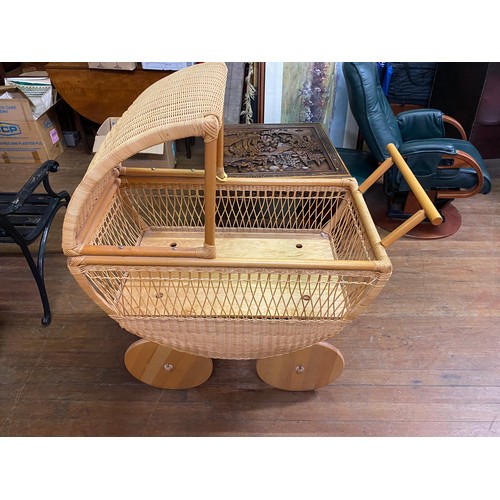 25 - Wicker dolls pram/moses basket with solid wood wheels. 95cm x 117 high