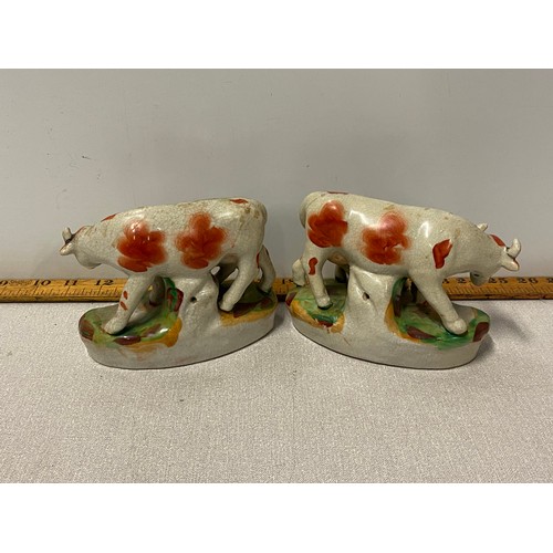 187 - Pair of antique Staffordshire pottery cow and calf ornaments. 
12cms high