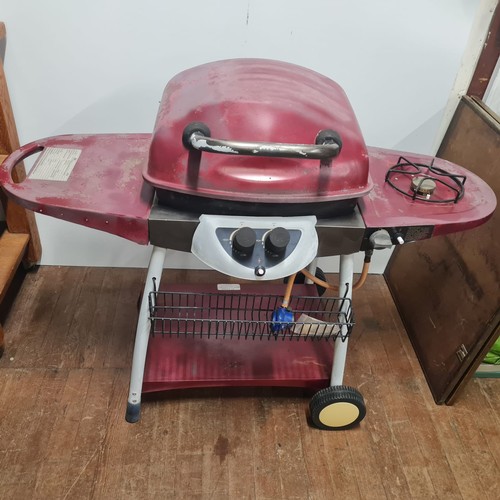 514 - Gas BBQ grill with utensils.