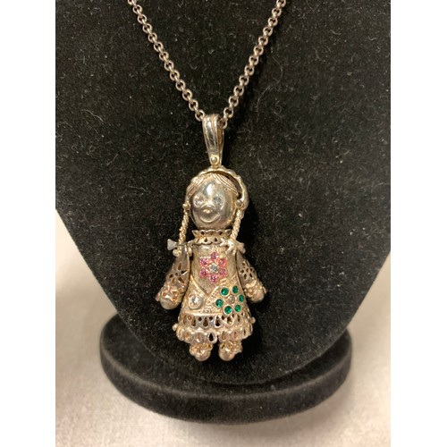 206 - Silver chain with large silver rag doll pendant encrusted with multi coloured stones.