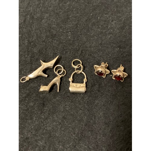 210 - 3 x silver charms along with silver and amber earrings.