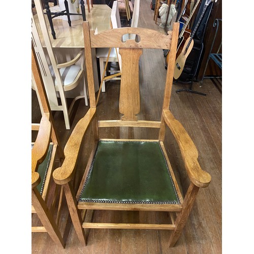 8 - Pair of Oak Arts and Crafts arm chairs with green leather seats.