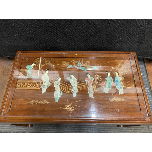 22 - Oriental coffee table decorated with mother of pearl geisha figures.
90cm l x 50cm d x 46cm h