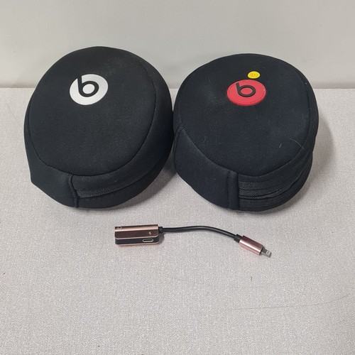 283 - 2 pairs of beats noise cancelling headphones with cases and I phone adapter.