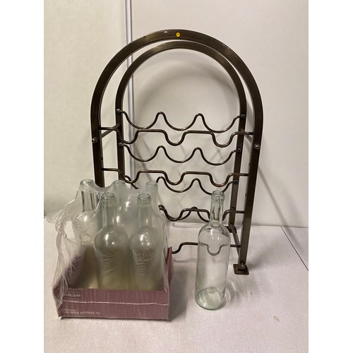 425 - Metal wine rack along with 6 new glass bottles.