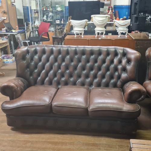 228 - Brown leather Chesterfield sofa and armchair.