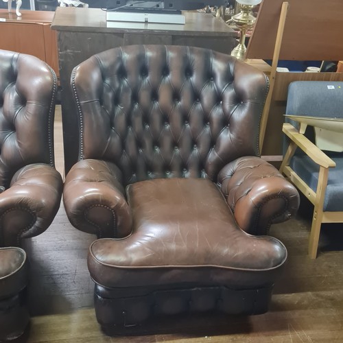 228 - Brown leather Chesterfield sofa and armchair.