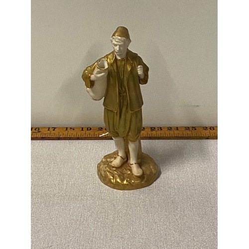 427 - A Royal Worcester man carrying an urn figure. [20cm high]