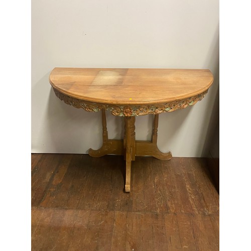 495 - Vintage oak half moon  table with carved floral design. Slight damage to the carving.
100cm x 76cm h... 