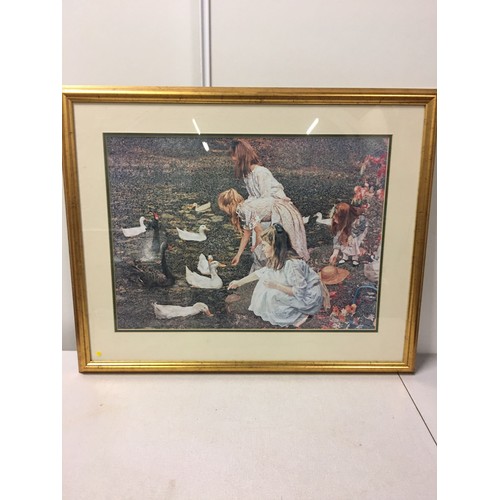 613 - Large framed signed print of girls feeding ducks.