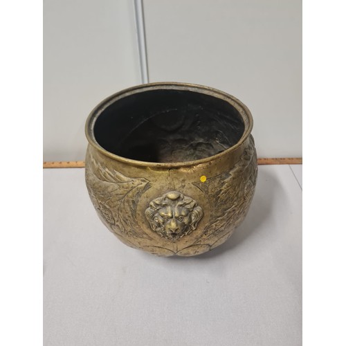 54 - Early 20th century brass planter/pot decorated with thistles and 2 lions.
29cm h