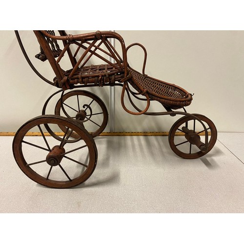 63 - Vintage ornate wicker 3 wheel dolls pram.
69cm h