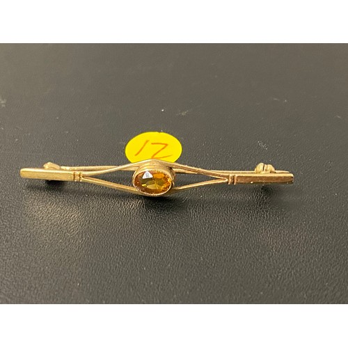 104 - 9ct Gold and yellow tourmaline brooch.