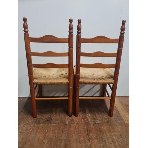 160 - Pair of arts and crafts ladder back chairs.