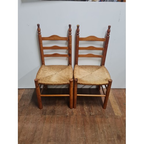 160 - Pair of arts and crafts ladder back chairs.