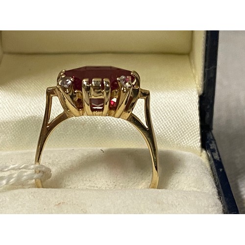 153 - 14ct gold dress ring set with large cut ruby and 4 white spined stones. Ruby 6x12x12mm. 5.78g