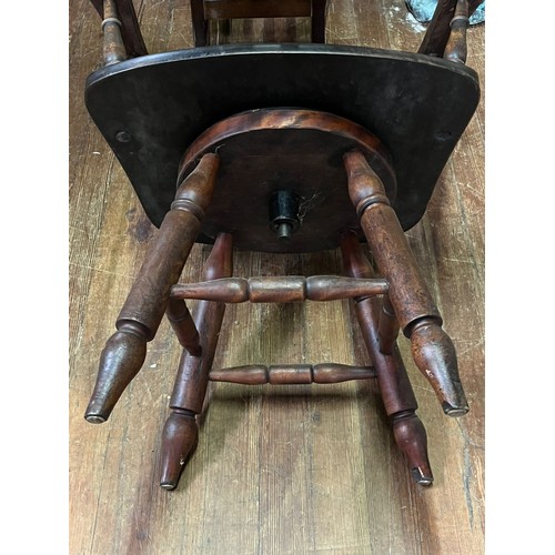 54 - Antique smokers bow/captain's chair with red leather studded seat.