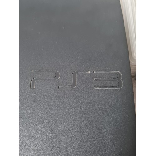 267 - PS3 Console with 2 controllers along with 11 games.