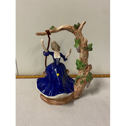 454 - Vintage ornament of lady on tree swing.
34cm h