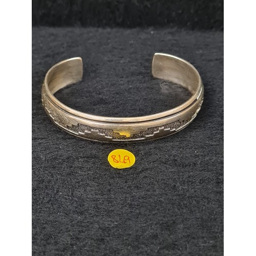 166 - Hallmarked silver Aztec style bangle.