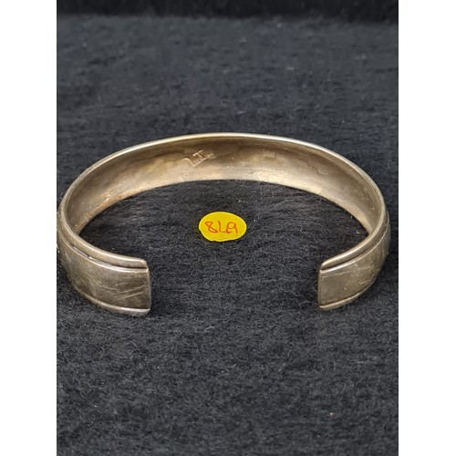 166 - Hallmarked silver Aztec style bangle.