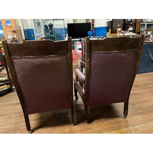 83 - Pair of Victorian Salon chairs on casters upholstered in plum leather.